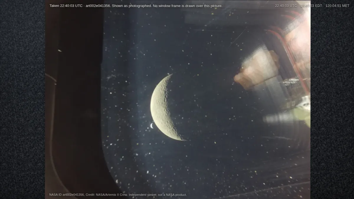 The Moon and Earth seen through an Orion window on the Artemis II lunar flyby.